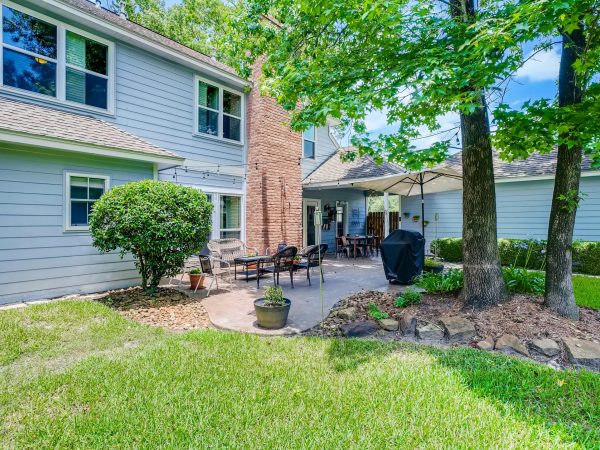 Beautiful residential backyard featuring a cozy patio and lush green surroundings.